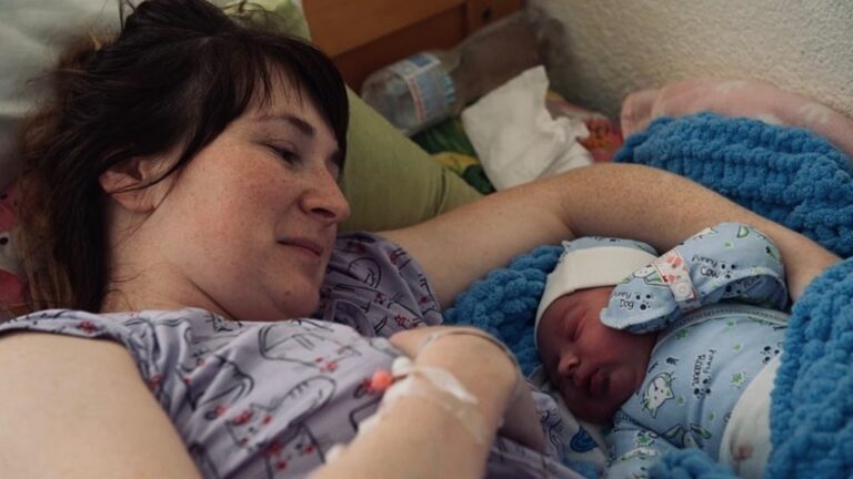 This mother and her newborn in Ukraine are in an unheated hospital. The baby is kept warm in a rechargeable infant incubator provided by SmartAid. Photo courtesy of SmartAid