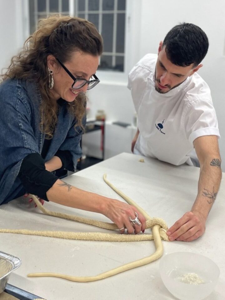 The Challah Prince guides a workshop participant in braiding the dough. Photo by Natalie Selvin