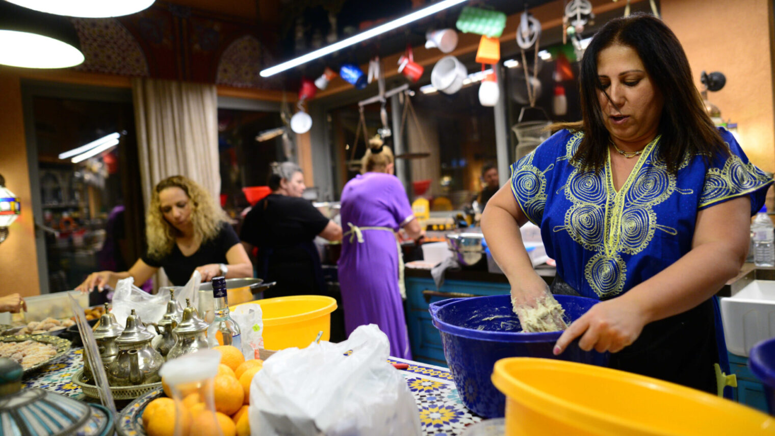 Members of the Turgeman Family prepare food at a Mimuna festival in Jaffa. Photo by Tomer Neuberg/Flash90