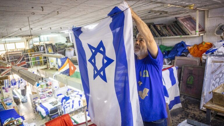 Workers making Israeli flags at Berman's Flags in Jerusalem on April 27, 2022, prior to Israeli Independence Day. Photo by Yonatan Sindel/Flash90