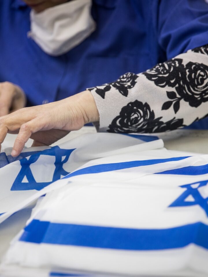 Workers making Israeli flags at Berman's Flags in Jerusalem on April 27, 2022, prior to Israeli Independence day. Photo by Yonatan Sindel/Flash90