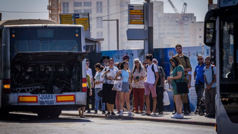 Passengers wait for buses at the entrance to Jerusalem. Photo by Olivier Fitoussi/Flash90