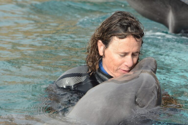Psychotherapist Sophie Donio with one of the dolphins at the Dolphin Reef, Eilat. Photo by Hadas Tsion