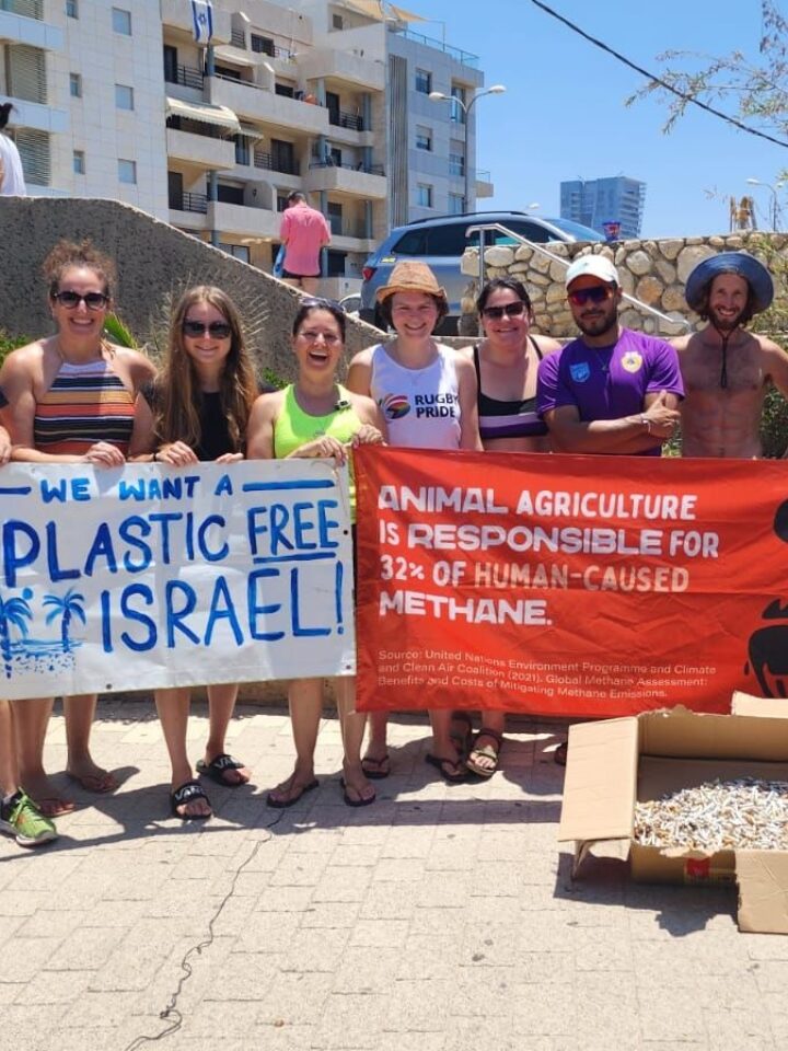 Clean the Butts founder Julian Melcer (shirtless in blue hat) with volunteers from Israeli environmental organizations at a July 1, 2023, cleanup event.  Photo courtesy of Clean the Butts