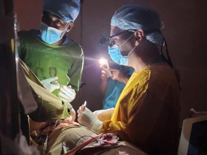 Performing surgery with smartphone flashlights in the operating room of St. Peterâ€™s Hospital in Ethiopia. Photo courtesy of Dr. Vasila Rechea