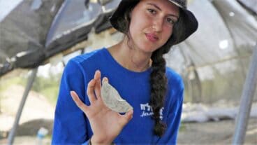 Aviv Weizman with her discovery. Photo by Emil Aladjem/Israel Antiquities Authority