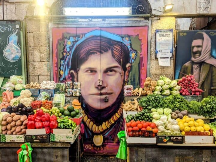 This market stall in Machane Yehudaâ€™s Agas (Pear) Street got a centennial facelift with portraits of the original houseâ€™s owners, Bachora and Meir Banai. Photo by Solomon Souza
