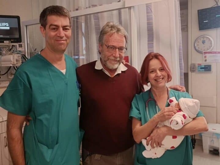 Dr. Noa Ofek Shlomai, right, head of neonatology at Hadassah University Medical Center, holding the newborn who successfully underwent surgery to save her ovaries. From left are Dr. Shay Porat, director of the obstetrics and gynecology ultrasound service, and Dr. Dan Arbel, director of the pediatric oncology surgery department. Photo courtesy of Hadassah