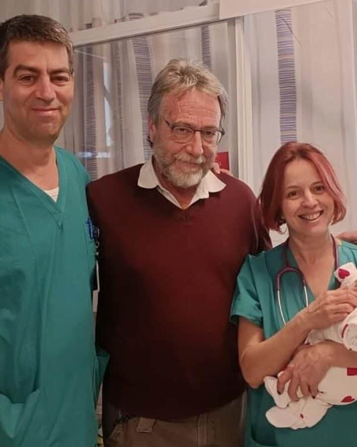 Dr. Noa Ofek Shlomai, right, head of neonatology at Hadassah University Medical Center, holding the newborn who successfully underwent surgery to save her ovaries. From left are Dr. Shay Porat, director of the obstetrics and gynecology ultrasound service, and Dr. Dan Arbel, director of the pediatric oncology surgery department. Photo courtesy of Hadassah