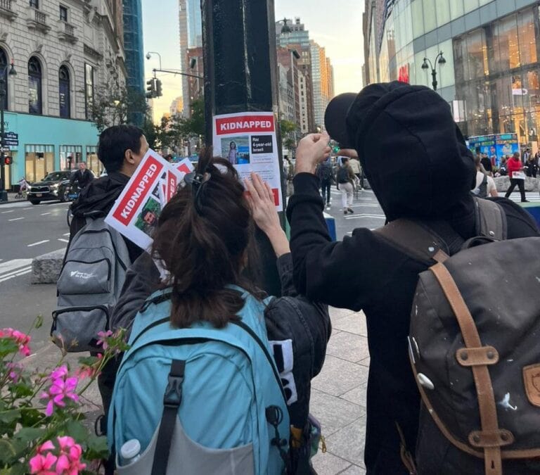 Dede and Nitzan putting up the flyers in New York. Photo courtesy of the Kidnapped from Israel campaign