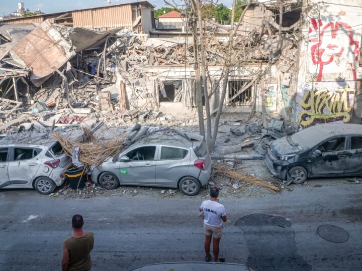Israelis examine the destruction after a building in Tel Avivâ€™s Florentin neighborhood was hit by a missile from Gaza on October 8. Photo by Avshalom Sassoni/Flash90