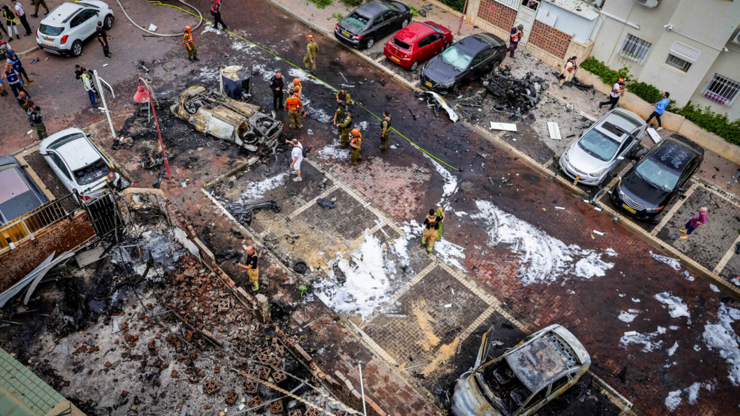 Israeli security and rescue forces at the scene where a rocket fired from the Gaza Strip hit buildings and cars in the southern Israeli city of Ashdod on October 9, 2023. Photo by Liron Moldovan/Flash90