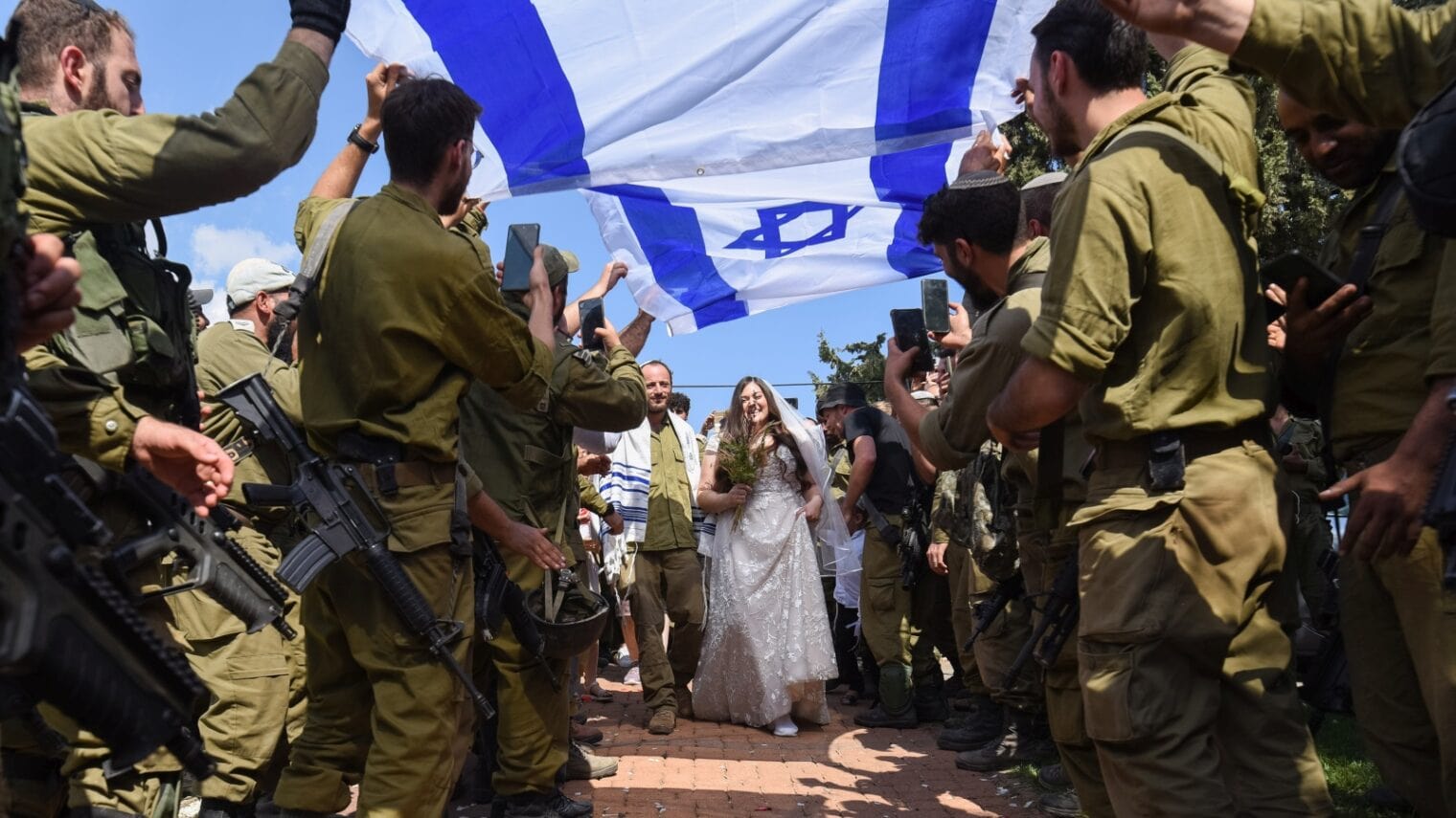 Family and friends in Moshav Dishon, northern Israel, celebrate a wedding early, as one of the spouses was called for reserve duty, October 12, 2023. Photo by Ayal Margolin/Flash90