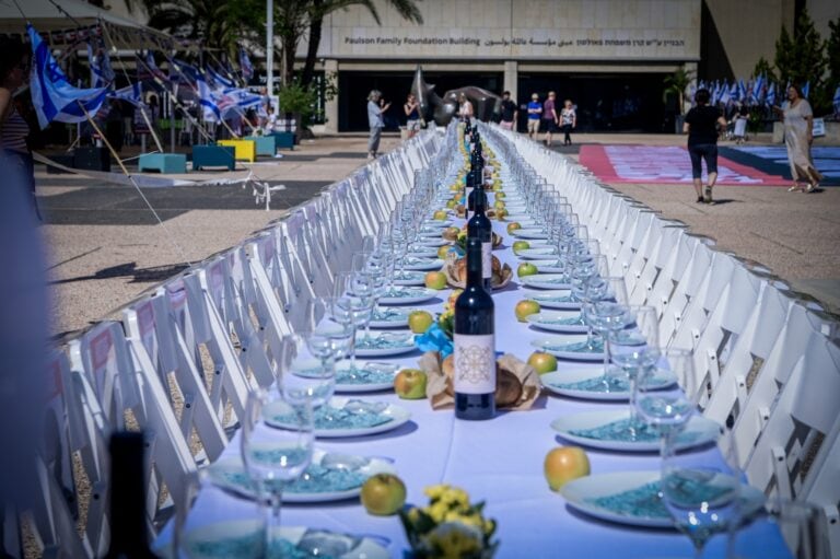 Families of Israelis held hostage by Hamas terrorists in Gaza set a symbolic Shabbat table with more than 200 empty seats for the hostages, outside the Tel Aviv Museum of Art, October 20, 2023. Photo by Avshalom Sassoni/Flash90