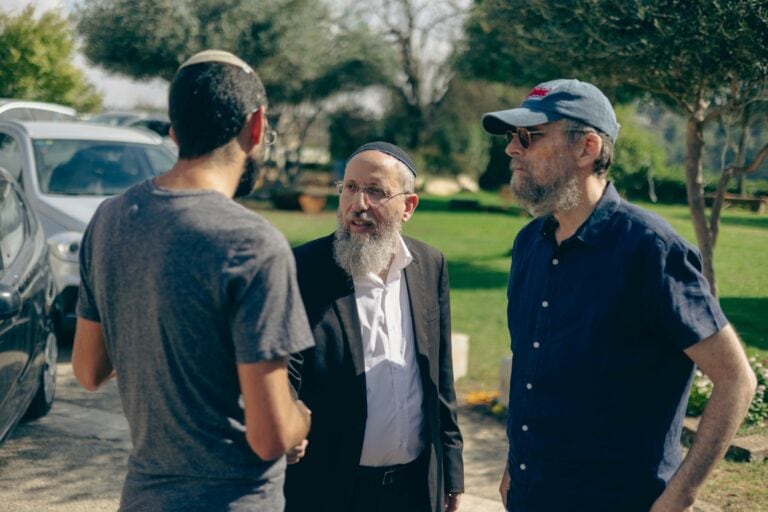Rabbi Yosef Tzvi Rimon, center, rabbi of the Gush Etzion Regional Council, with evacuees from Shlomit near the Gaza border who are sheltering in Gush Etzion south of Jerusalem. Photo courtesy of JNF-USA