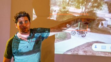 Eyal Barad showing a still from his CCTV camera showing a neighbor being abducted on a motorbike. Photo by John Jeffay