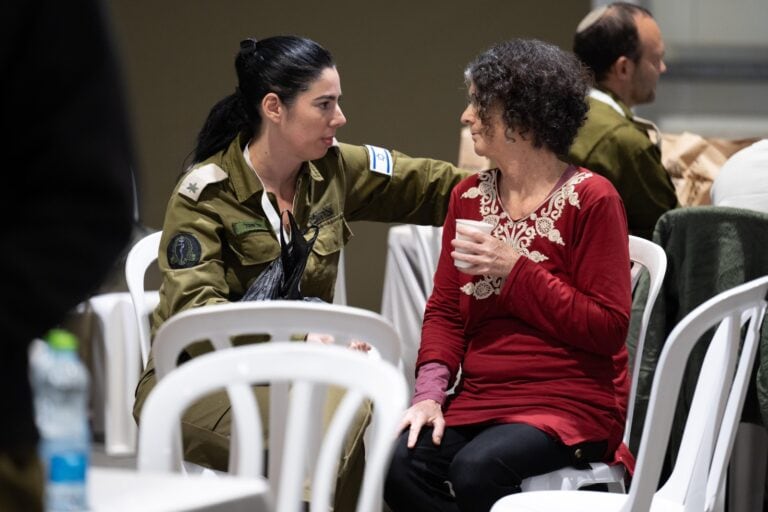 Shoshan Haran being consoled by a soldier upon her arrival in Israel. Photo courtesy of Prime Minister’s Office
