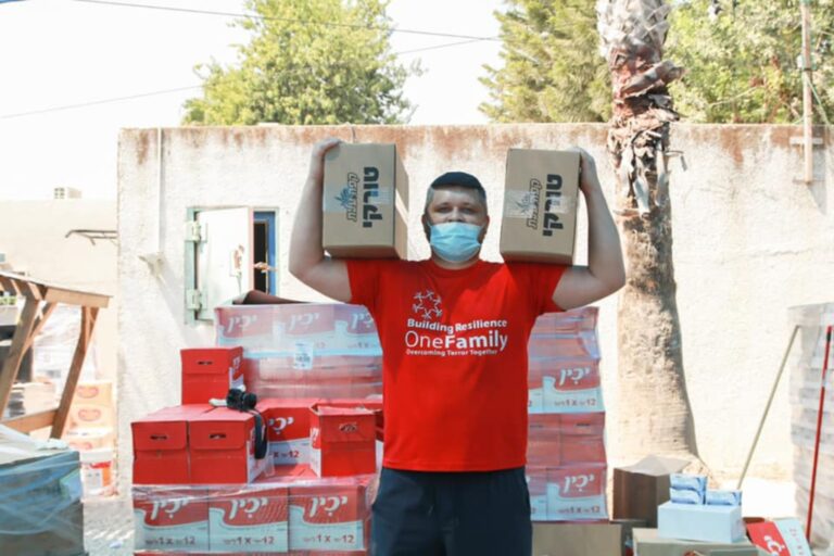 A OneFamily volunteer delivering pantry staples to victims of terror. Photo courtesy of OneFamily