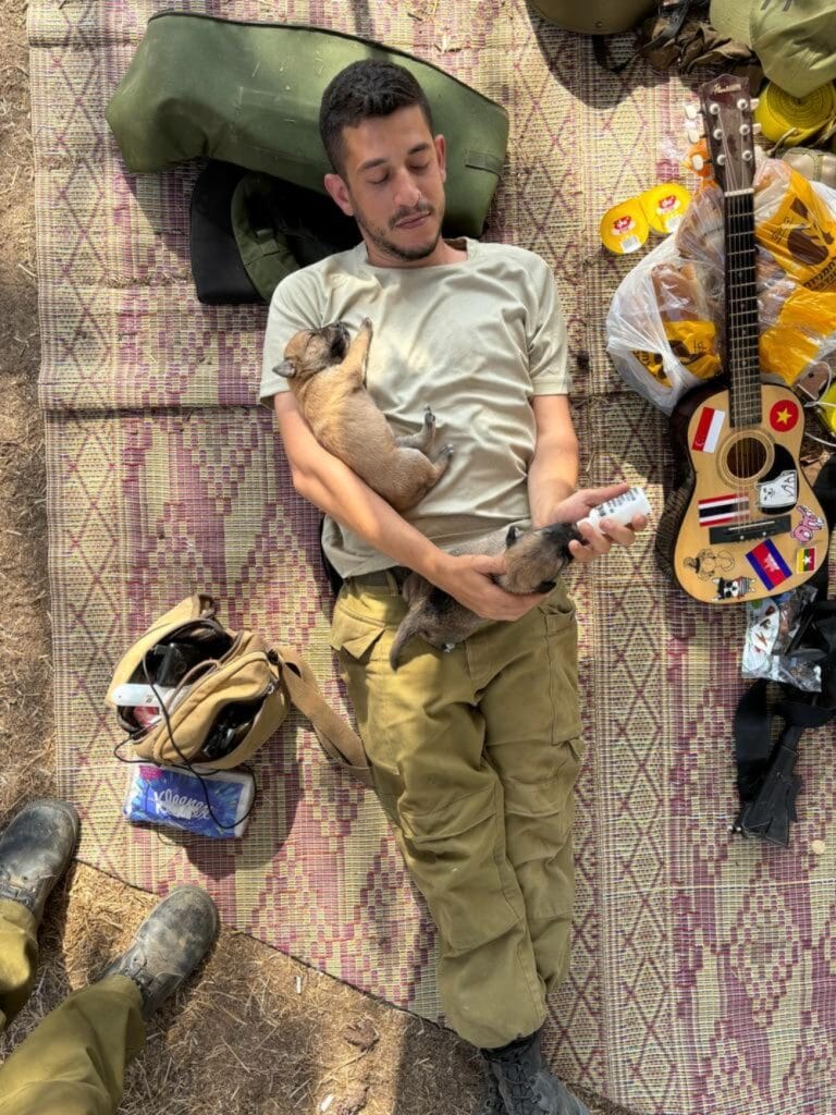 Sa’ar Berkowitz feeding the puppies he rescued. Photo courtesy of Ilana Curiel