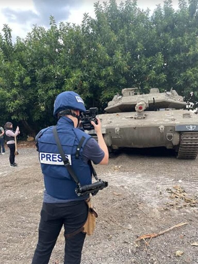 A foreign journalist participating in JPC's tour of the Israeli-Lebanese border photographs an IDF position. Photo courtesy of the Jerusalem Press Club