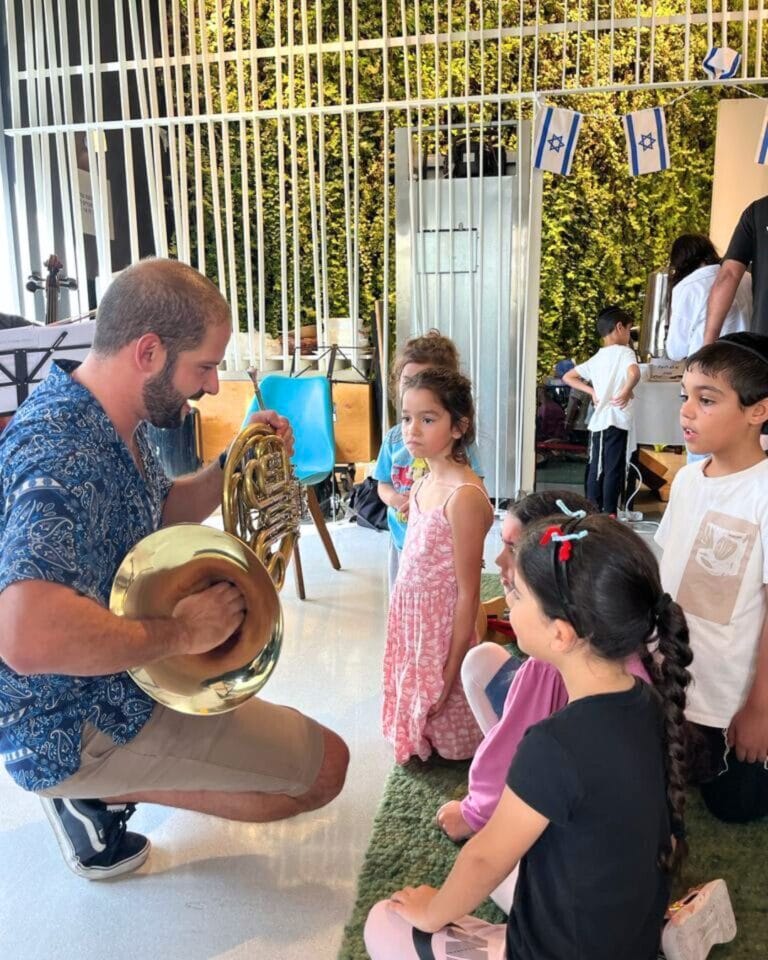 Israel Philharmonic musicians play instruments for healing