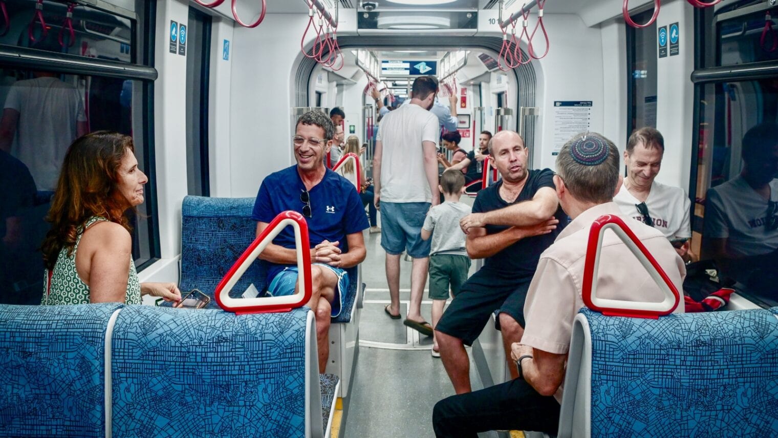 Passengers on Tel Avivâ€™s Metropolitan Light Rail chatting with each other. Photo by Avshalom Sassoni/Flash90