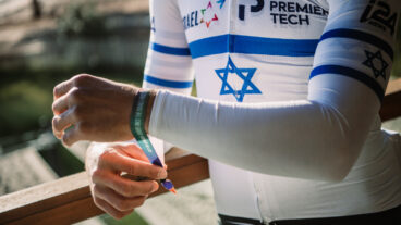 Israeli cycling champion Itamar Einhorn attaching a ribbon to his bike in solidarity with the hostages. Photo courtesy of Israel â€“ Premier Tech