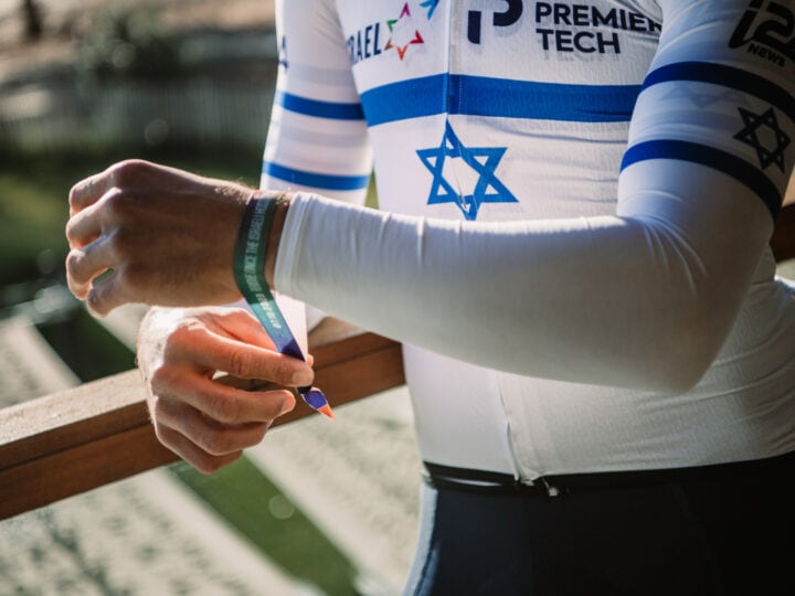 Israeli cycling champion Itamar Einhorn attaching a ribbon to his bike in solidarity with the hostages. Photo courtesy of Israel – Premier Tech