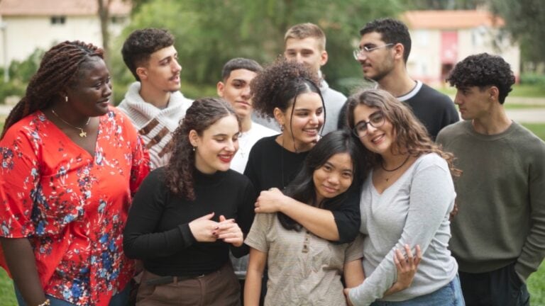 Local and international students hugging each other. Photo courtesy of Givat Haviva International School