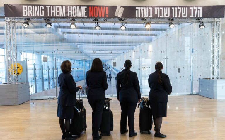 Flight crews pause to look at the dog tag exhibition at Ben-Gurion Airport. Photo by Barak Ziv