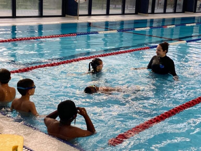 Ella Azaria instructing children of Ethiopian descent. Photo courtesy of Swimming Toward Resilience