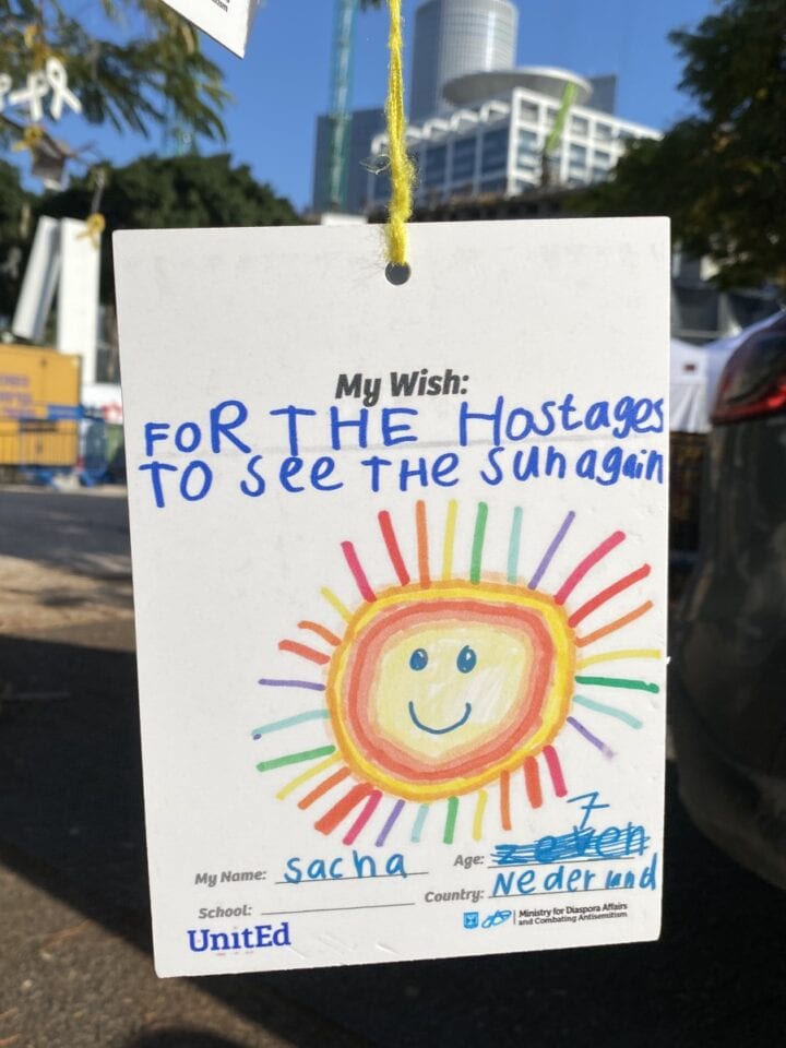 This message from a Dutch child, hanging from a tree in Hostages and Missing Square in Tel Aviv, is part of the UnitEd project of the Ministry of Diaspora Affairs and Combating Antisemitism