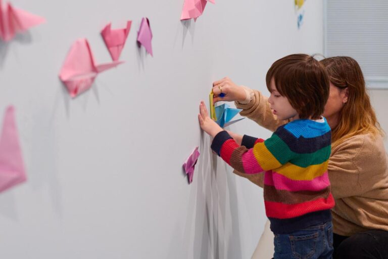 Children adding their origami creatures to the walls of “Looking for a Rainbow” at the Tel Aviv Museum of Art. Photo by Dor Kedmi
