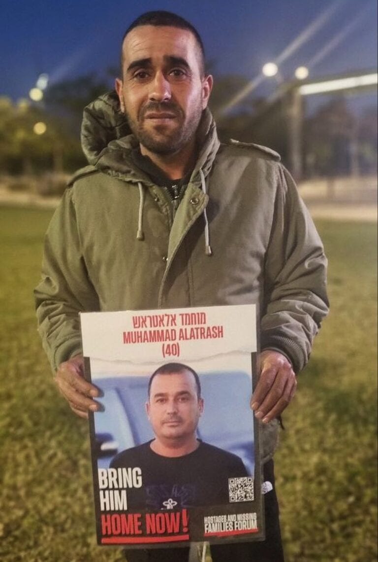 Salem Alatrash holding an image of his missing brother. Photo by Yulia Karra 