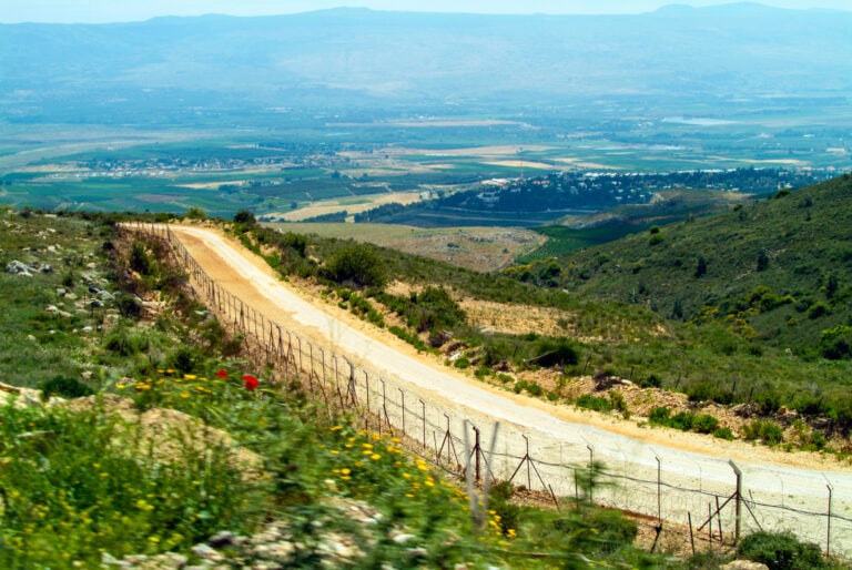 View of the Israel-Lebanon border demarcated by an electrified security fence. Photo by David Dennis via Shutterstock.com