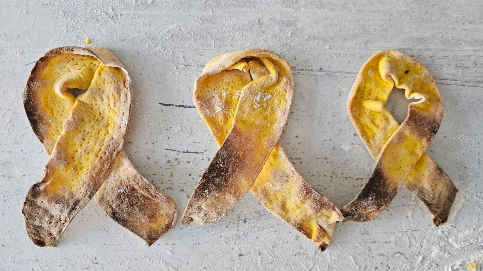 Idan Chabasov uses turmeric to make matzah resembling the yellow ribbons showing solidarity with the hostages in Gaza. Photo courtesy of Challah Prince