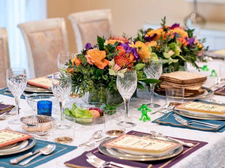 A Passover table setting with a floral centrepiece. Photo by LCRP via Shutterstock.com