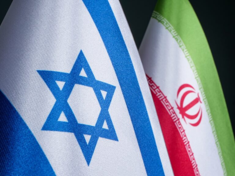 The Israeli and Iranian flags. Photo by Vitalii Vodolazskyi via Shutterstock.com