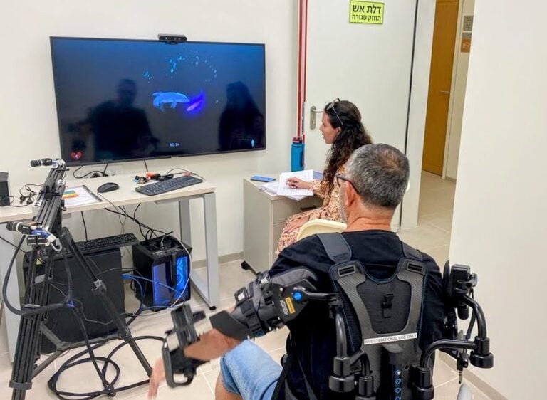 Utilizing gaming technology developed at Johns Hopkins University, a patient controls a dolphin on a screen by moving his arms, reaching personal rehab goals with every fish the dolphin catches. Photo courtesy of ADI Negev-Nahalat Eran