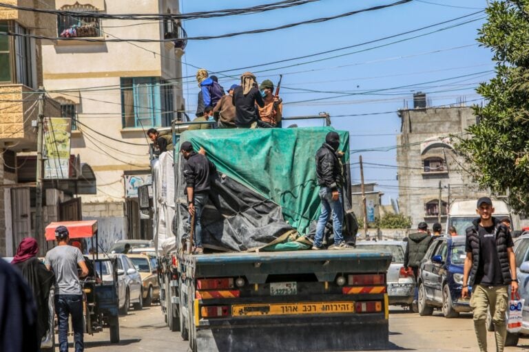 Armed Palestinians on trucks loaded with international humanitarian aid entering Gaza through the Israeli Kerem Shalom Crossing, southern Gaza Strip, April 3, 2024. Photo by Abed Rahim Khatib/Flash90