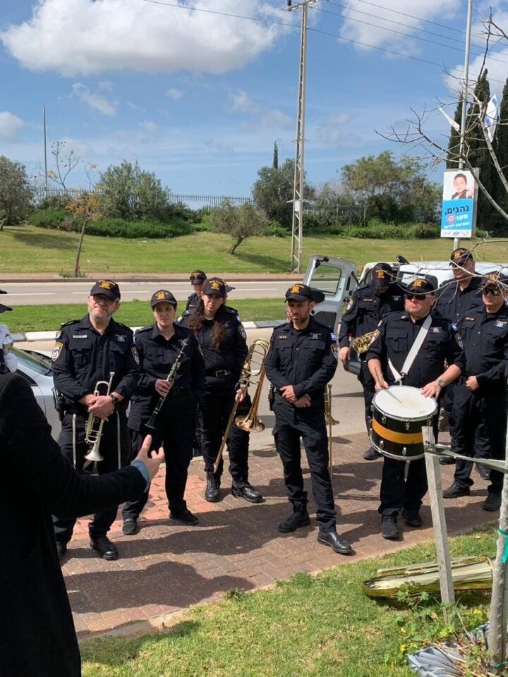 Gilad Segev filming a tribute to hero Aner Shapira in Kochav Yair, Israel, with members of the police orchestra. Photo courtesy of Gilad Segev