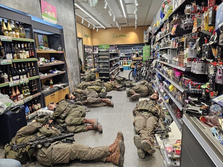 Soldiers resting at an Alonit gas station on the night between October 7 and October 8. Photo by Batia Holin, survivor of the massacre at Kibbutz Kfar Aza